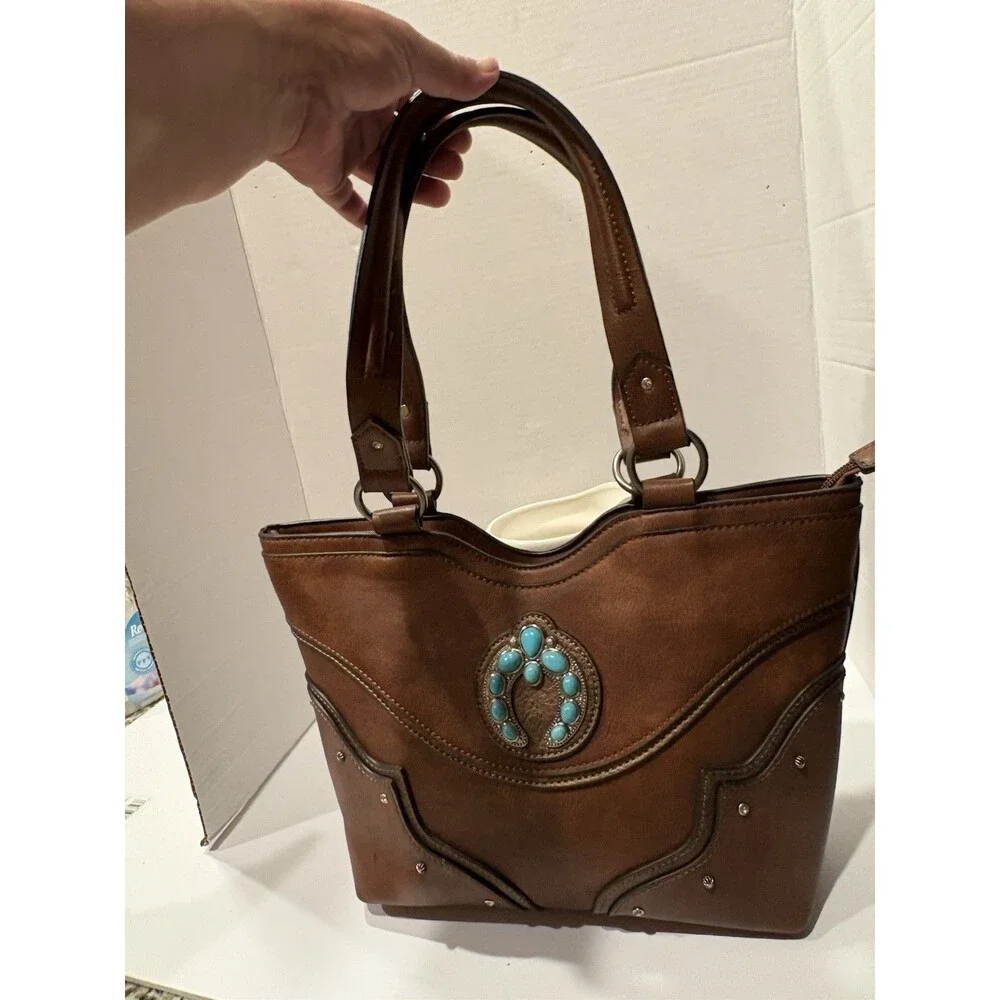 brown faux-leather Justin Naja Concho bag accented with a turquoise